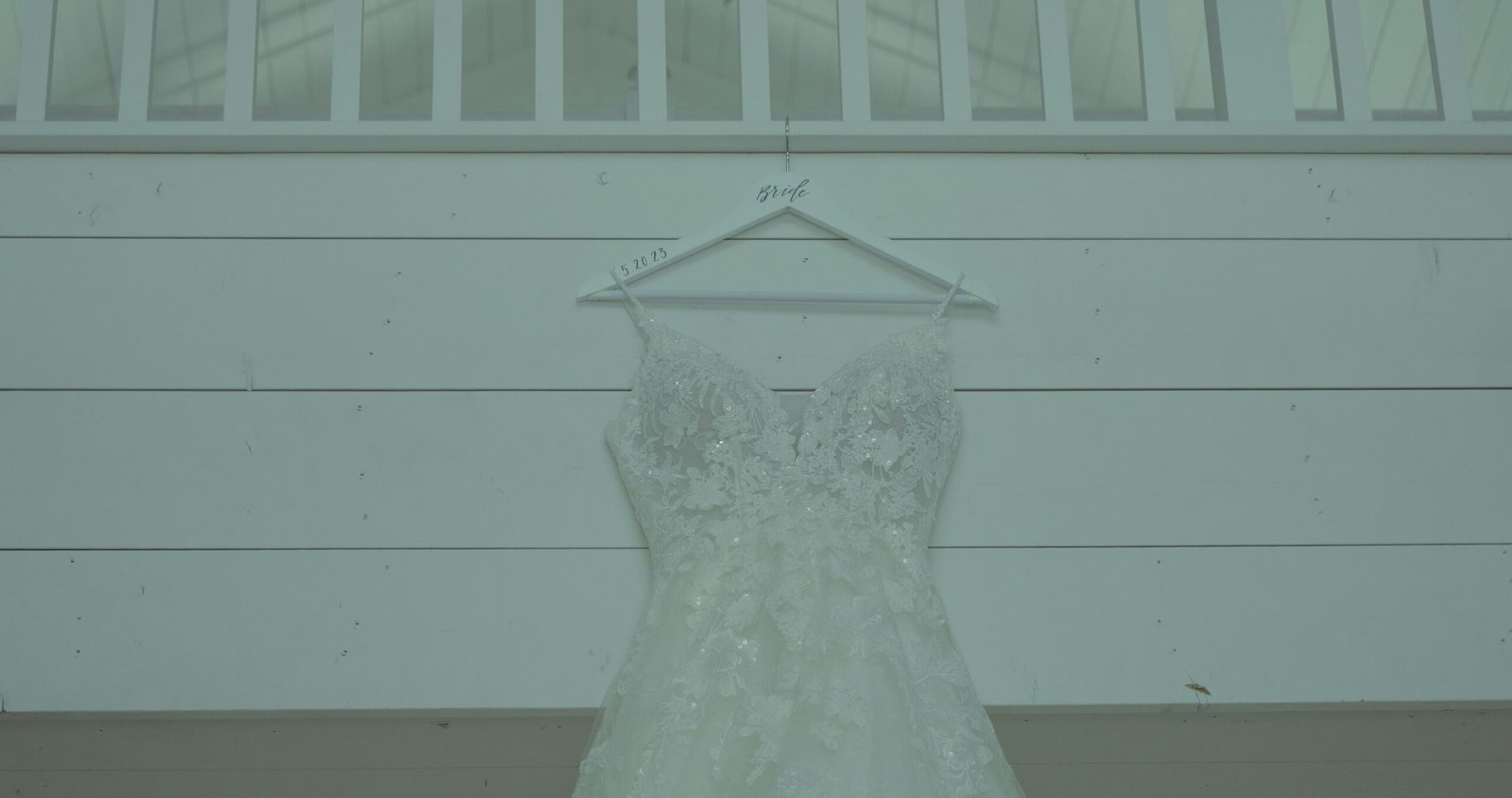 a wedding dress hanging on a hanger